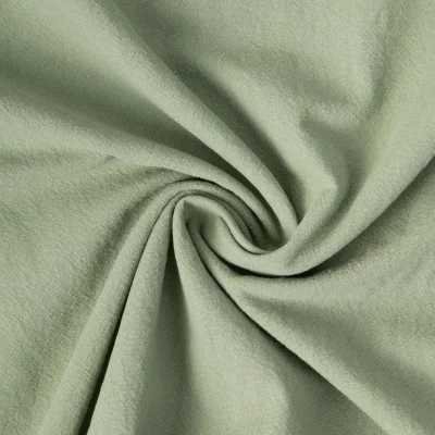 Tissu Coton Lavé aspect Lin uni Vert amande - Par 10 cm