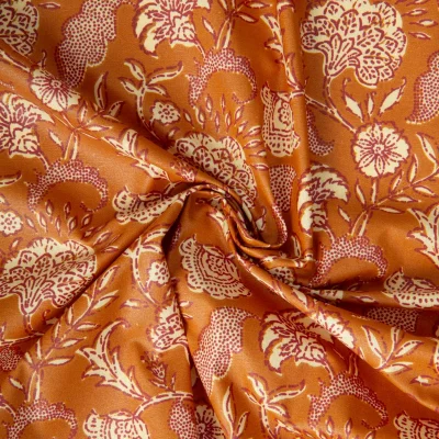 Tissu Coton enduit Agra fleuris sur fond Rouille - Par 10 cm