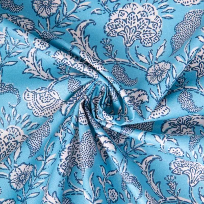 Tissu Coton enduit Agra fleuris sur fond Bleu turquoise - Par 10 cm