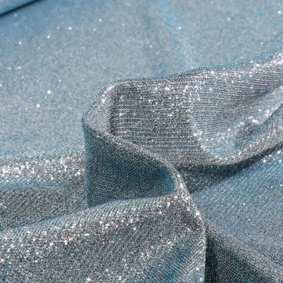 Tissu Jersey Lurex Pailleté sur fond Givre reflets bleus - Par 10 cm