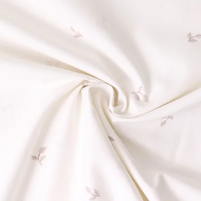 Tissu Popeline de Coton  feuilles Elia sur fond Ecru - Par 10 cm