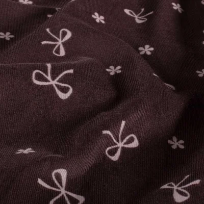 Tissu Velours milleraies Isaé noeuds Roses sur fond Prune foncé - Par 10 cm