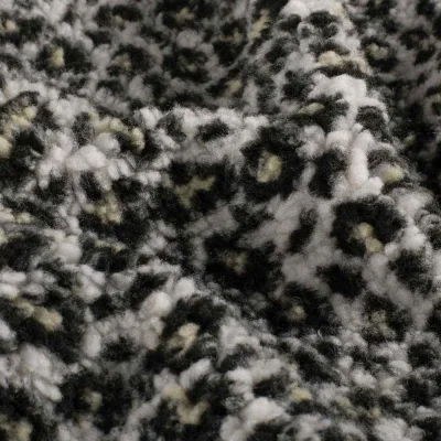 Tissu Fausse fourrure Mouton Yséa  léopard effet moucheté sur fond Blanc - Par 10 cm