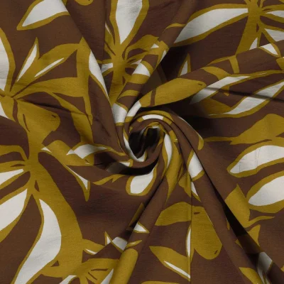 Tissu crêpe de viscose imprimé Fleuris blanc et or sur fond Marron - Par 10 cm