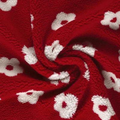 Tissu Bouclette Sherpa imprimé Fleurs Blanc sur fond Rouge - Par 10 cm