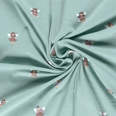 Tissu Jersey Coton imprimé Petites fées sur fond Bleu ciel - Par 10 cm