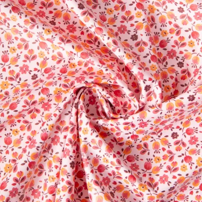 Tissu Imperméable imprimé Fleuris Caseille sur fond Rose clair - Par 10 cm