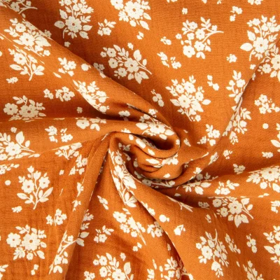 Tissu Double gaze de Coton Osma fleuris sur fond Orange - Par 10 cm