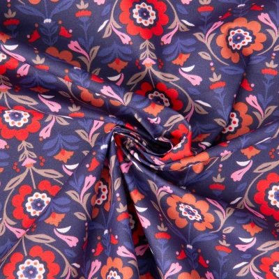 Tissu Coton Enduit Reine fleuris rouge sur fond Bleu foncé - Par 10 cm