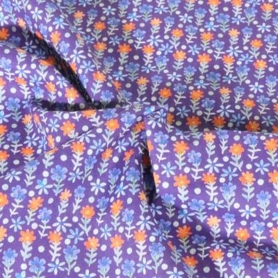 Tissu Popeline de Coton légère Petites fleurs sur fond Lilas - Par 10 cm