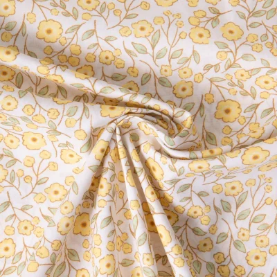 Tissu Popeline de Coton légère floral printanier jaune sur fond Blanc - Par 10 cm
