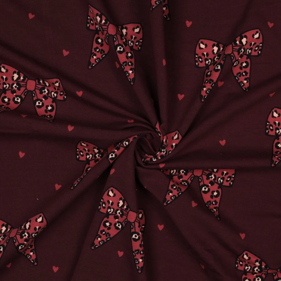 Tissu Sweat léger French Terry Manon noeuds et coeurs Rouge sur fond Bordeaux foncé