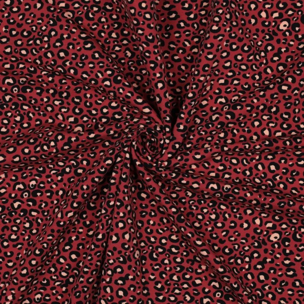 Tissu Sweat léger French Terry Léopard Noir et Ecru sur fond Rouge