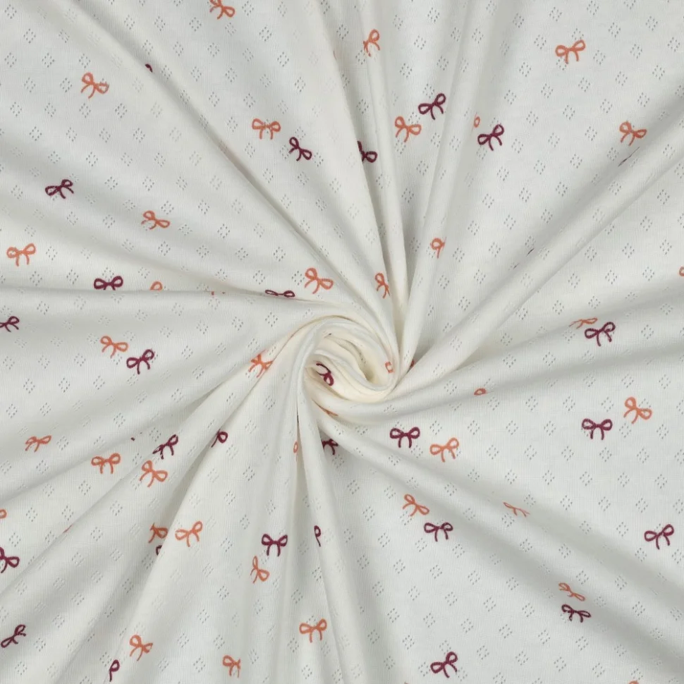 Tissu Jersey Coton ajouré Baby petits nœuds sur fond Blanc