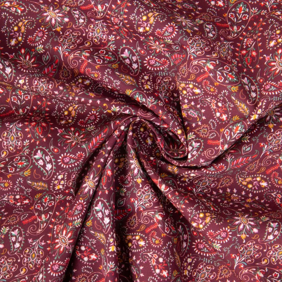 Tissu Popeline de Coton motifs paisleys floraux sur fond Bordeaux
