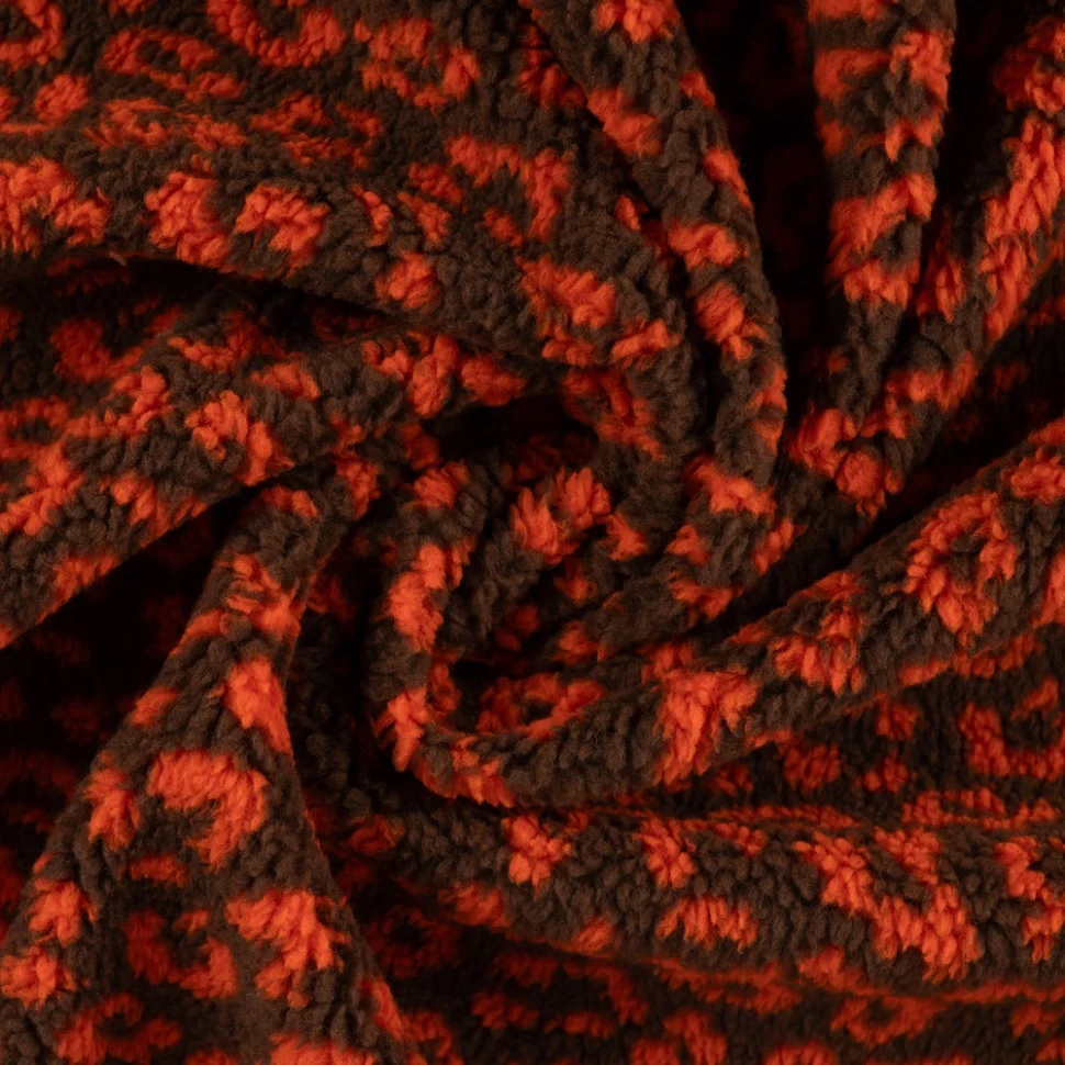 Tissu Teddy Bouclettes motif léopard Orange sur fond Marron