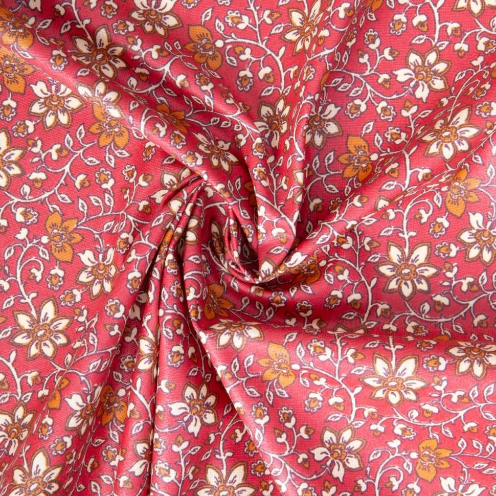 Tissu Coton enduit Goa fleuris sur fond Framboise