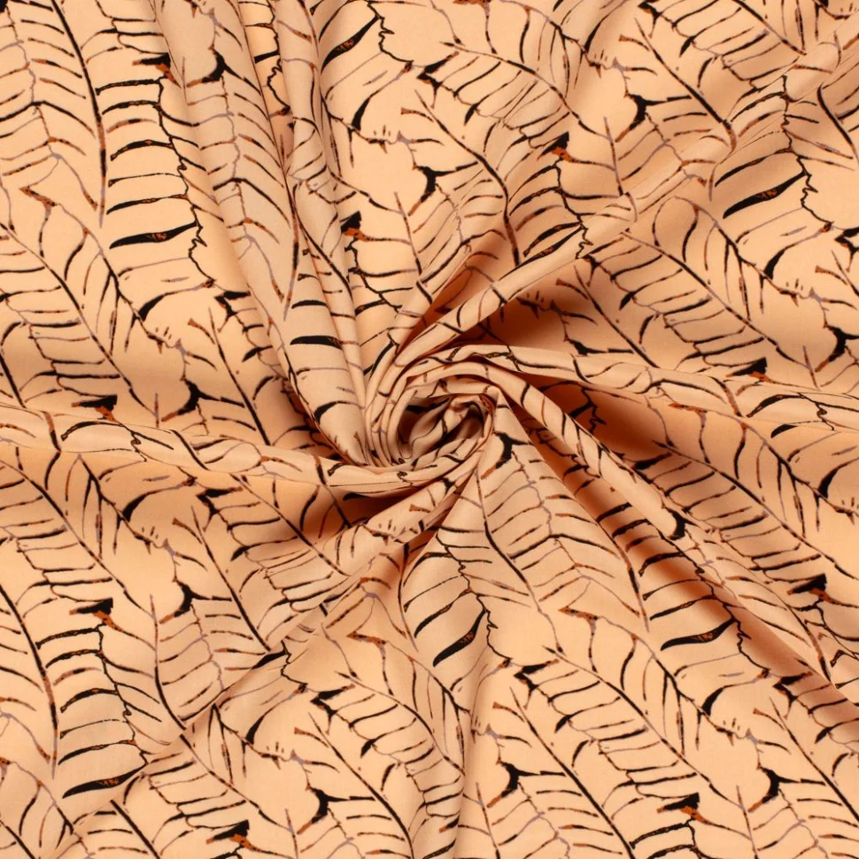 Tissu Popeline de Viscose imprimé Feuilles noires sur fond Saumon