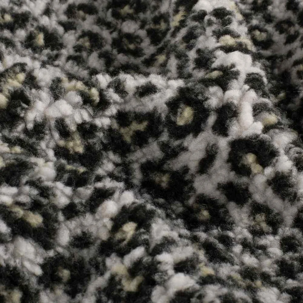 Tissu Fausse fourrure Mouton Yséa  léopard effet moucheté sur fond Blanc