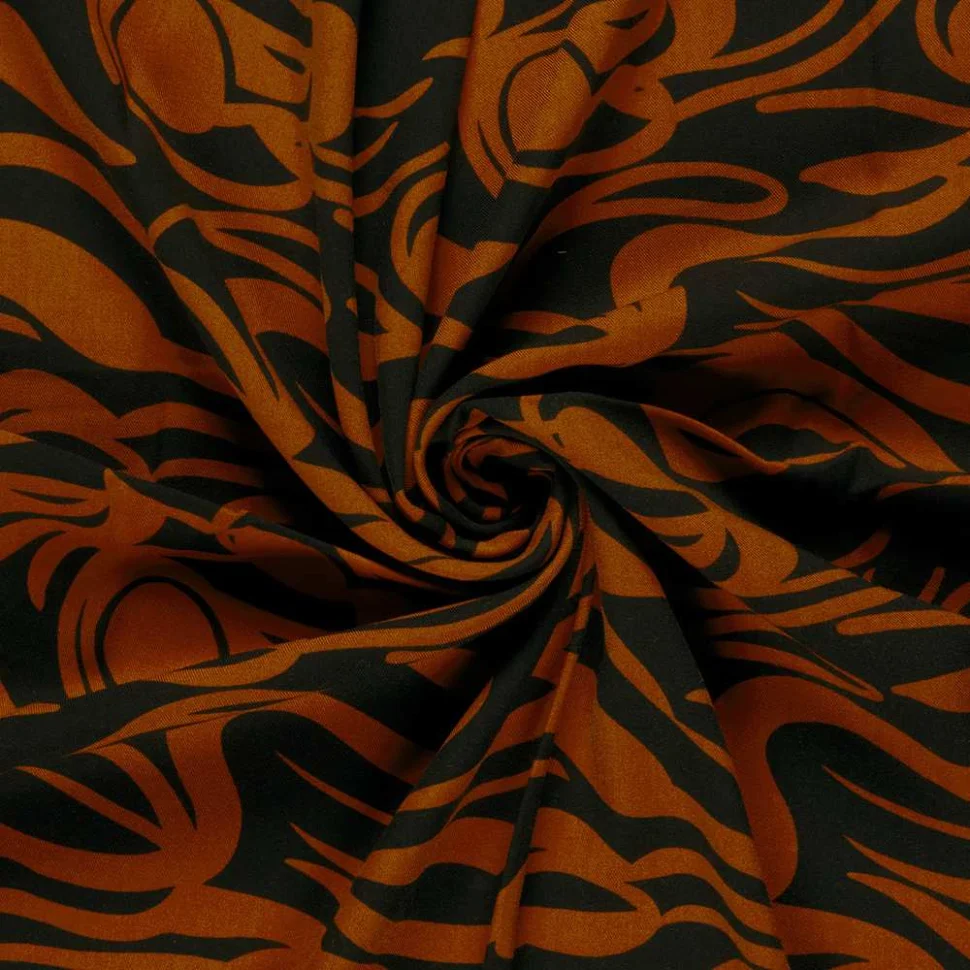 Tissu Viscose twill Pia arabesques sur fond Rouille