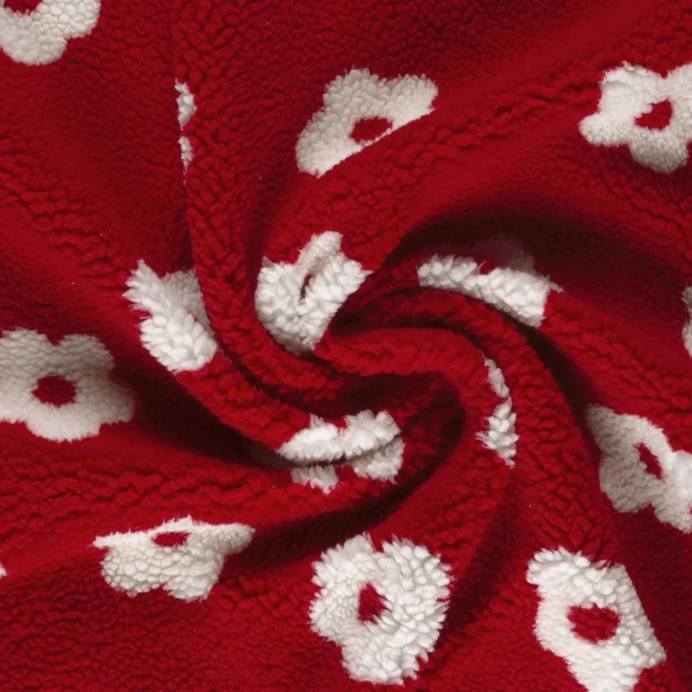 Tissu Bouclette Sherpa imprimé Fleurs Blanc sur fond Rouge